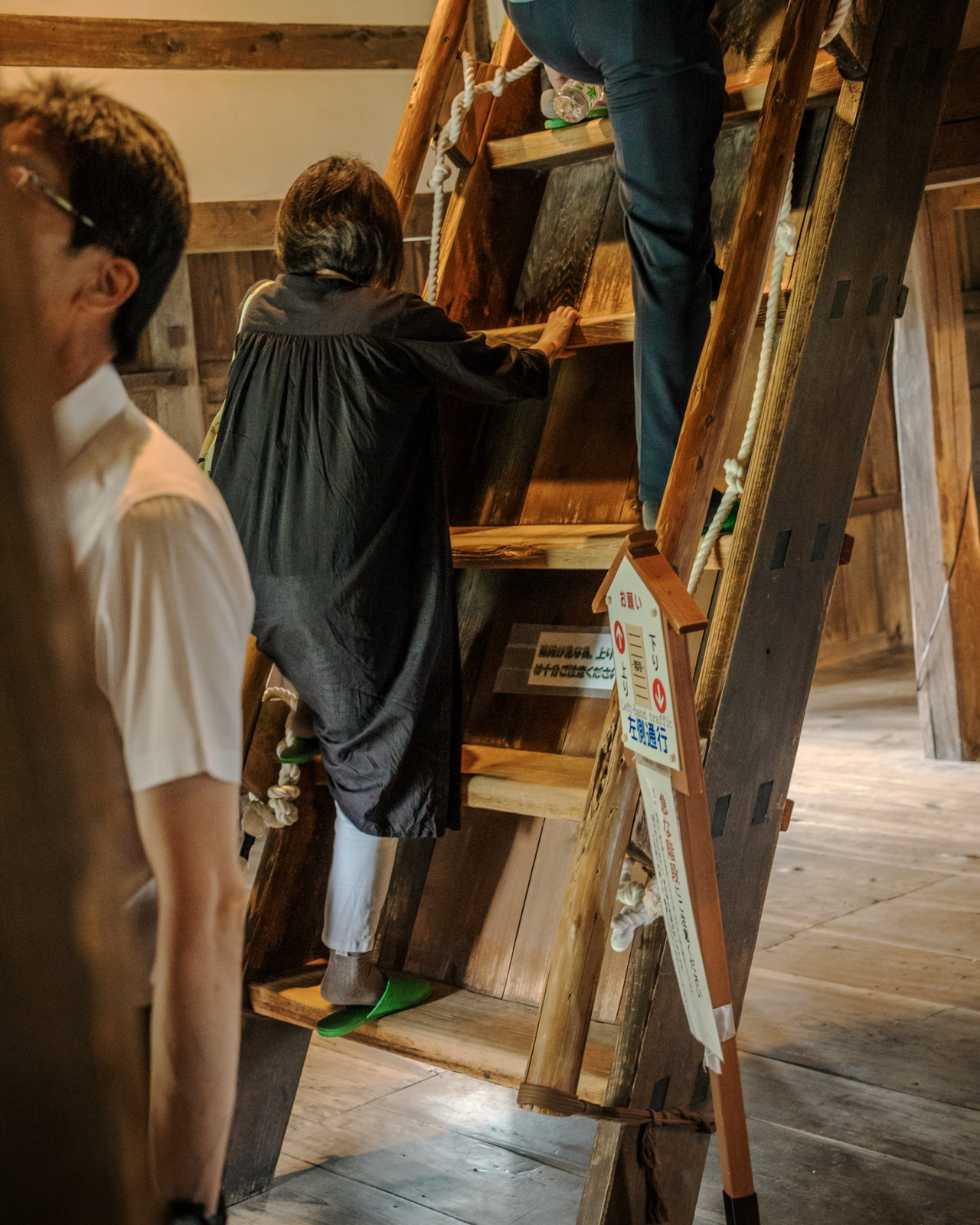 Extremely steep wooden staircase with a hand rope inside Maruoka Castle.