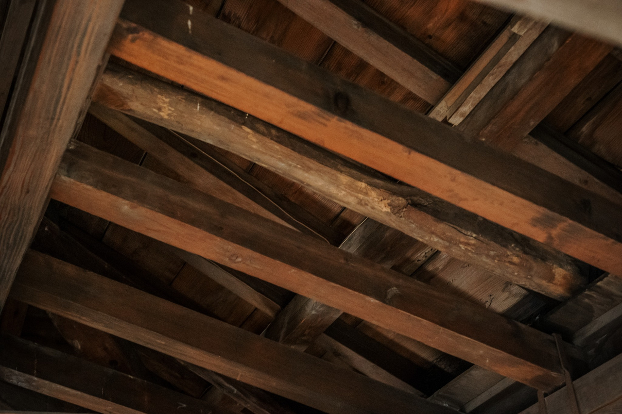 Exposed dark wooden roof beams inside the upper floor of Maruoka Castle keep.