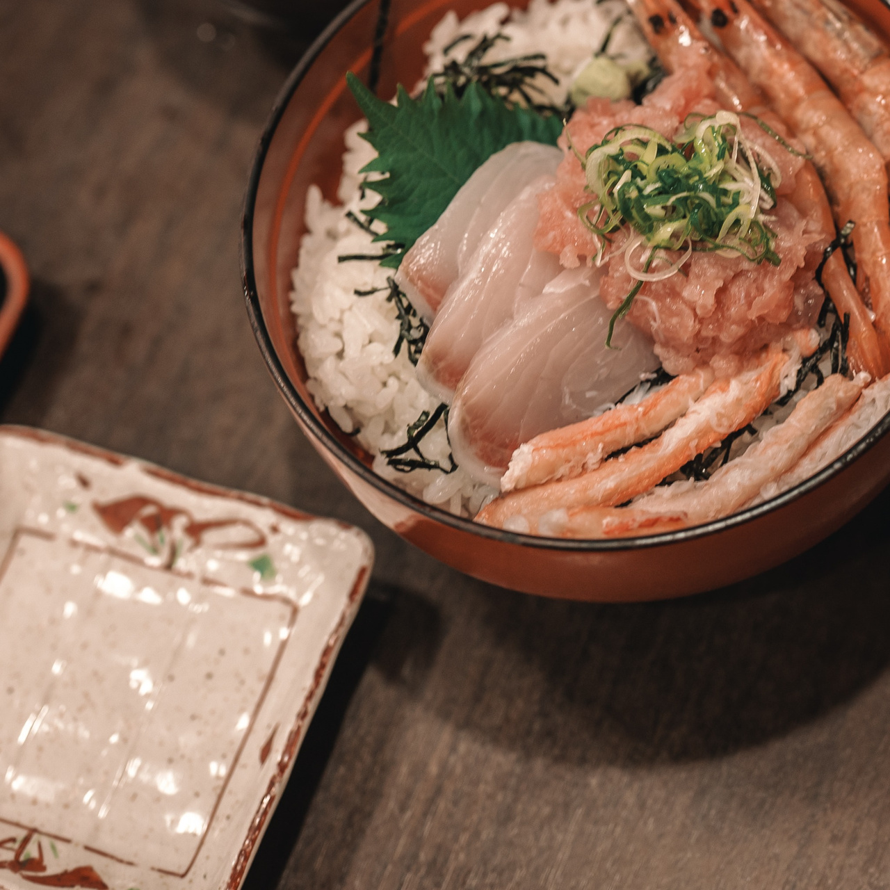 Seafood rice bowl topped with sweet shrimp and assorted local seafood near Tojinbo.