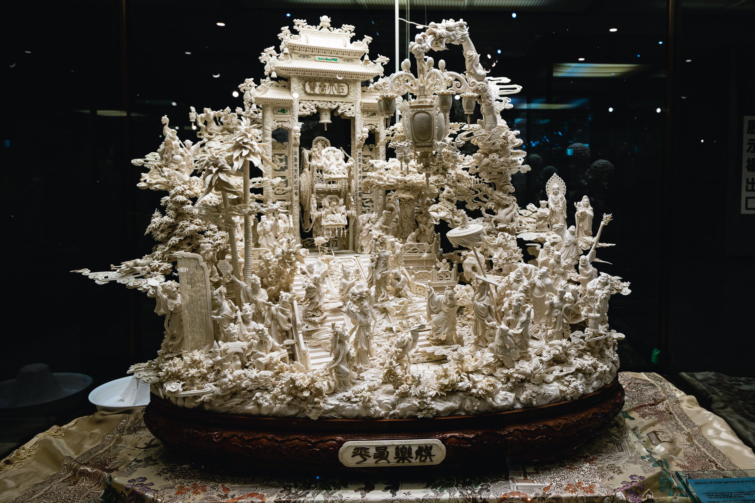 A large ivory carving crowded with gateways, figures and lanterns at Jewelpia.