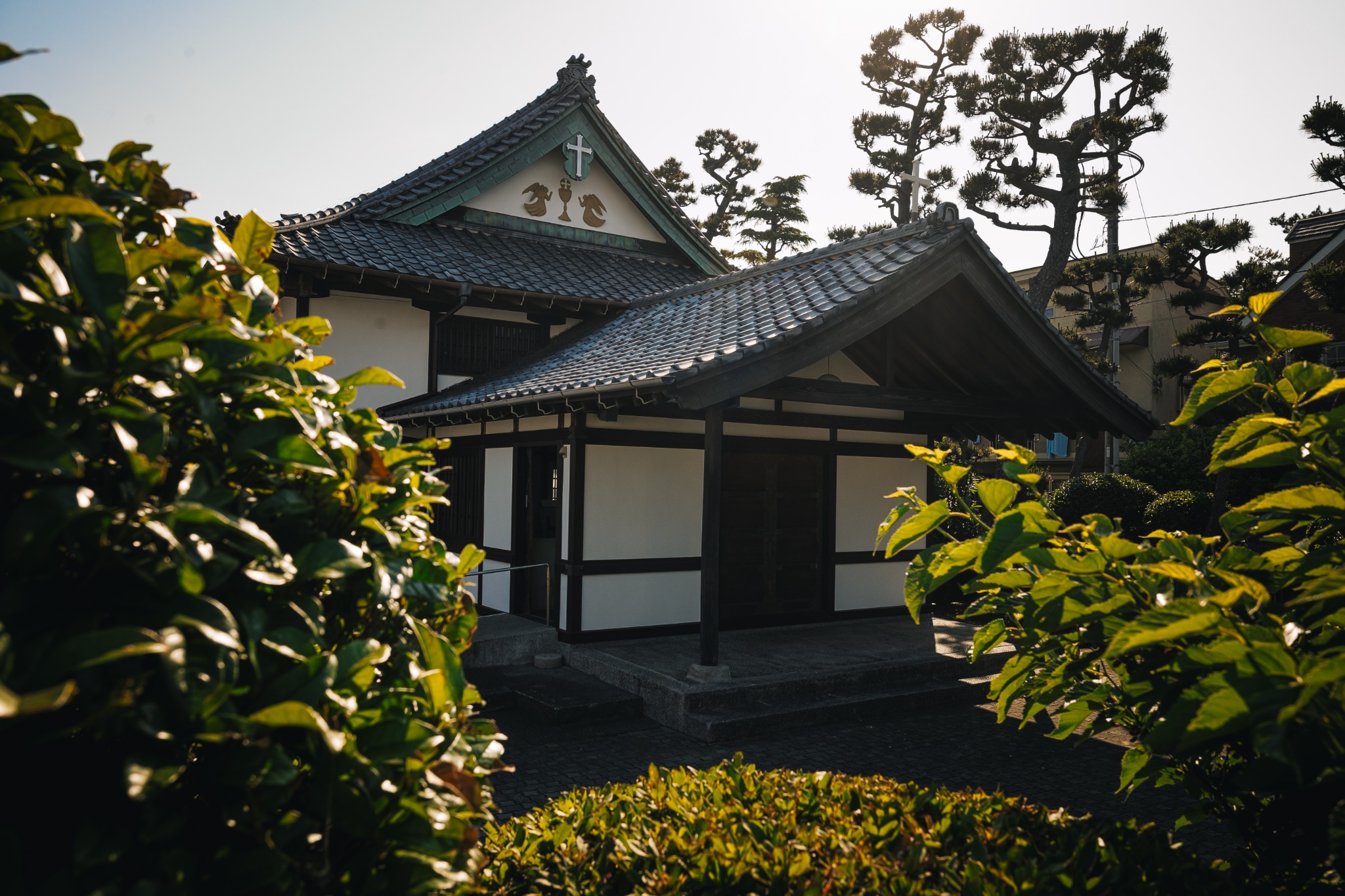Japanese-style Catholic church with a tiled roof, white plaster walls and timber framing in Katase near Enoshima.