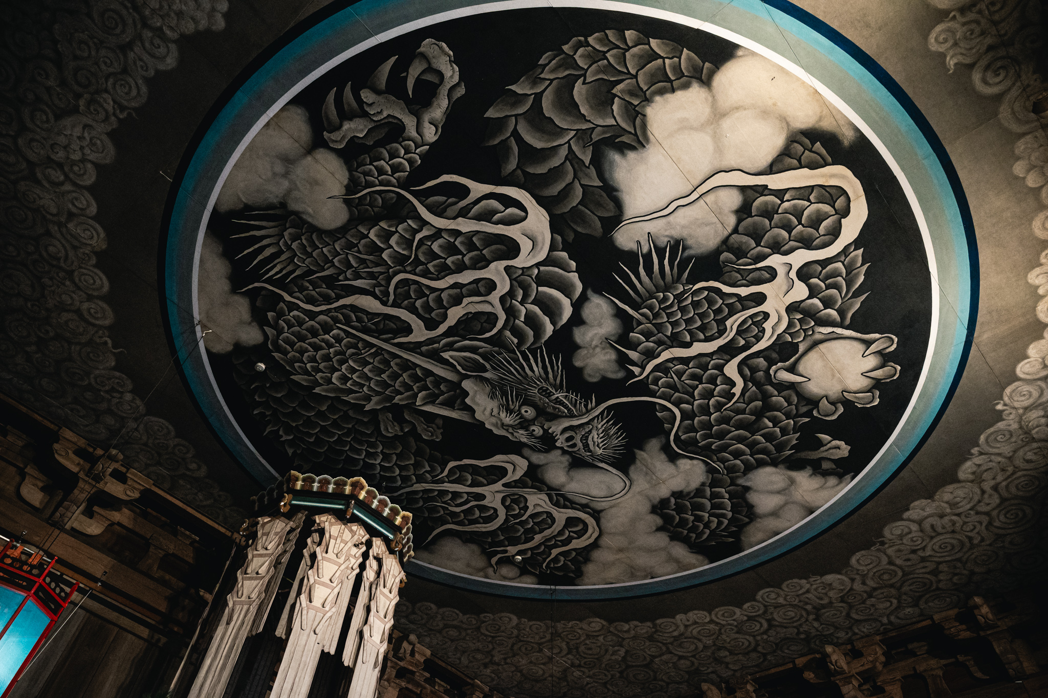 The Unryūzu dragon painting across the Dharma Hall ceiling at Kenchōji Temple, with hanging streamers below.