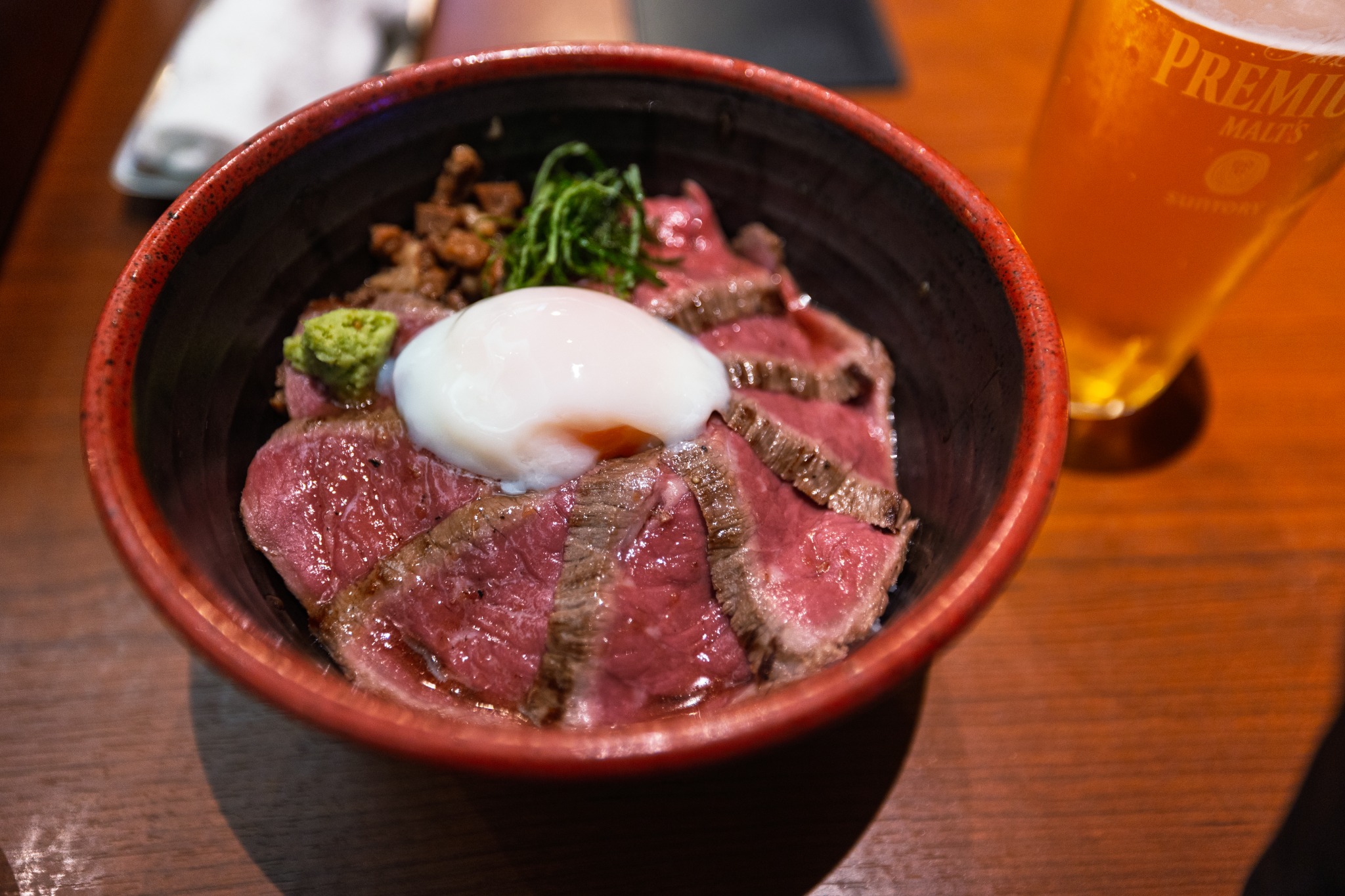 Akaushi don at yoka-yoka in Kumamoto, with rare seared beef arranged around an onsen egg and wasabi.