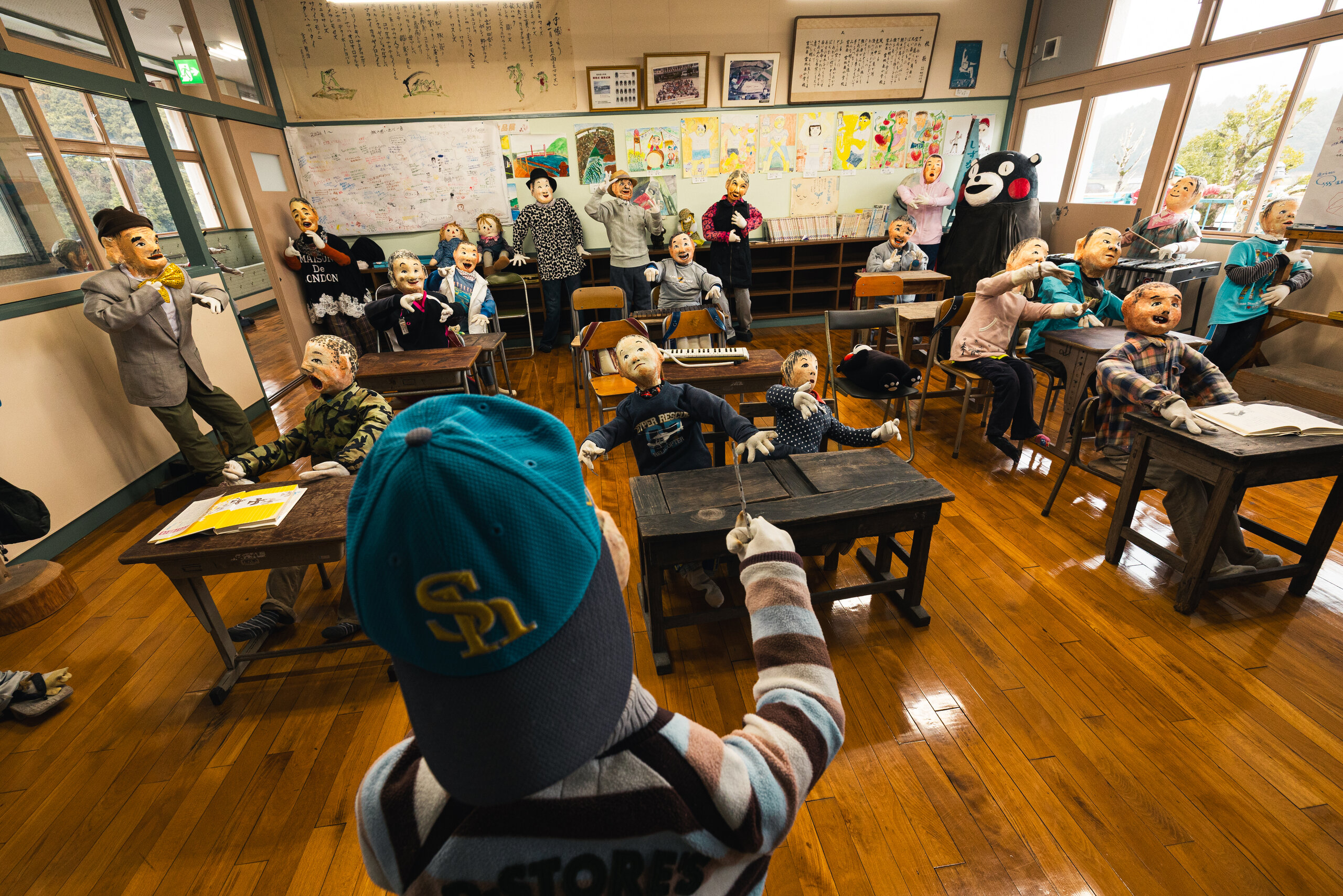 A classroom of handmade scarecrows seated at desks in Miyajidake Scarecrow Village in Amakusa, Kumamoto.