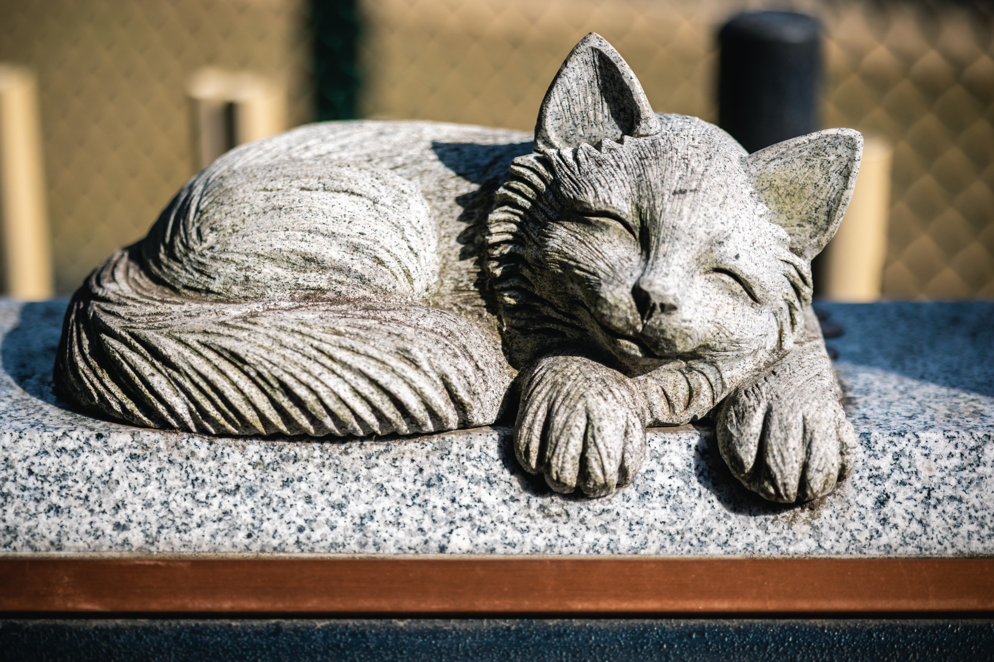 Reclining stone cat on top of the Nekozuka memorial in Yokohama.